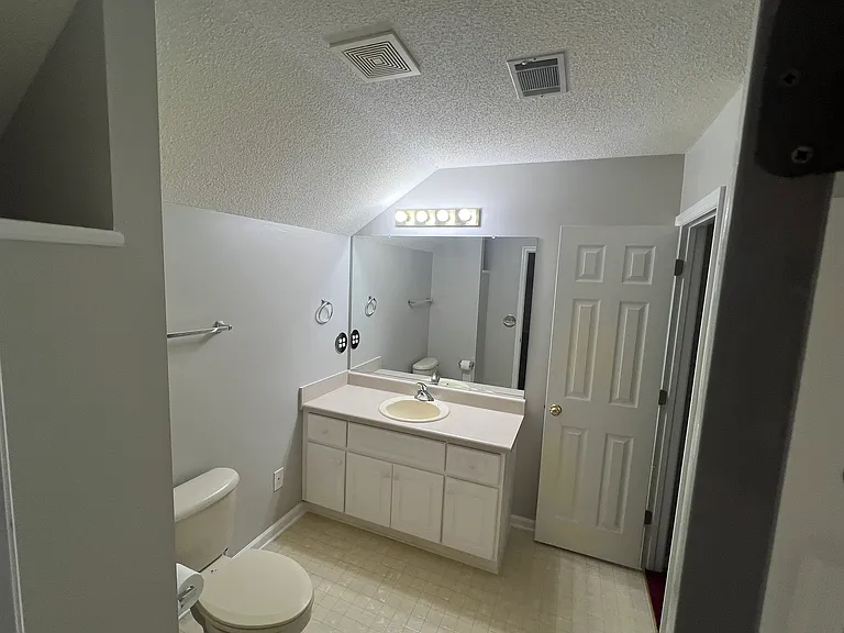 Upstairs bedroom/bonus room bathroom with walkin shower and entrance to closet