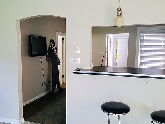 This kitchen is large enough to fit a table and features a pass through bar area to the living room. Lots of room for entertaining and relaxing. Side door can be used for guests. Please note Frank Sinatra is not included with this rental. :)