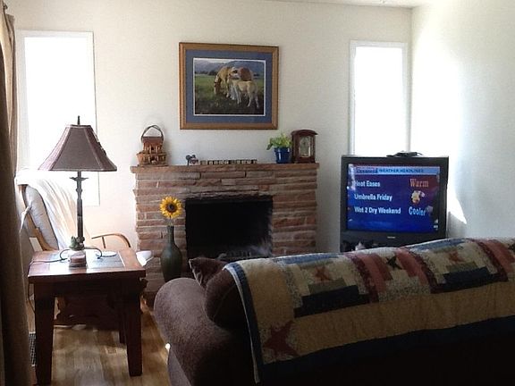Standing in the Entryway and to the Left is the Living Room with a Fireplace.