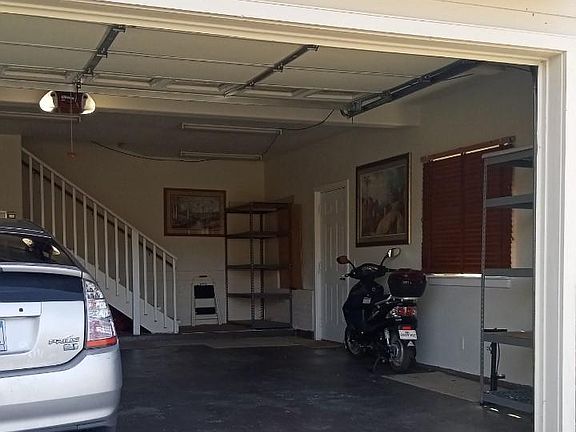 Right side of garage includes 2 storage shelves