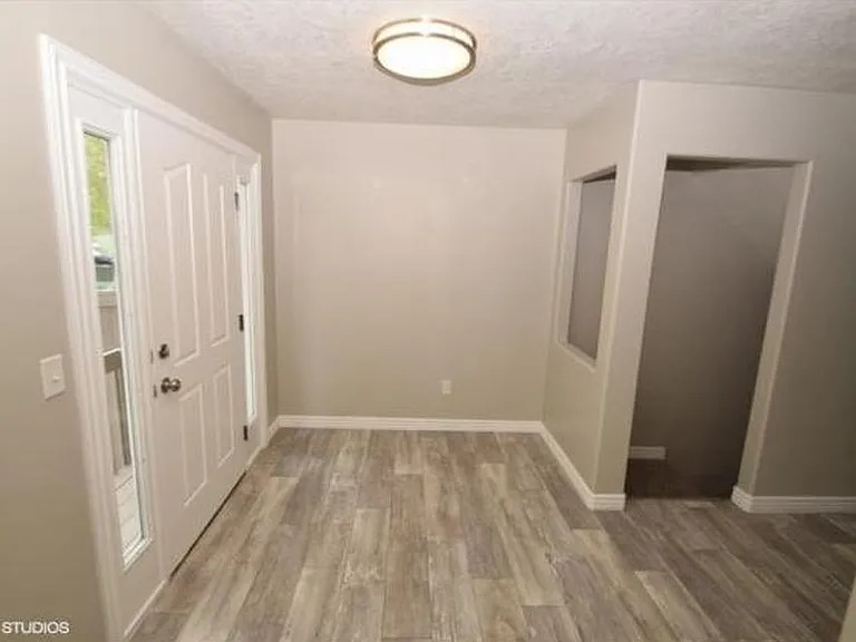 Back door entrance to kitchen and downstairs entrance.