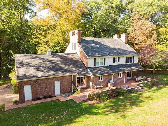 This is the back of the house.  The man doors go to the garage. The patio is brick and opens to the kitchen. The far seating arrangement opens to the Dining room