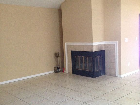 living room with vaulted ceiling and fireplace