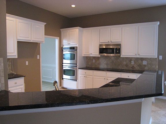 Kitchen overlooks family room with breakfast bar