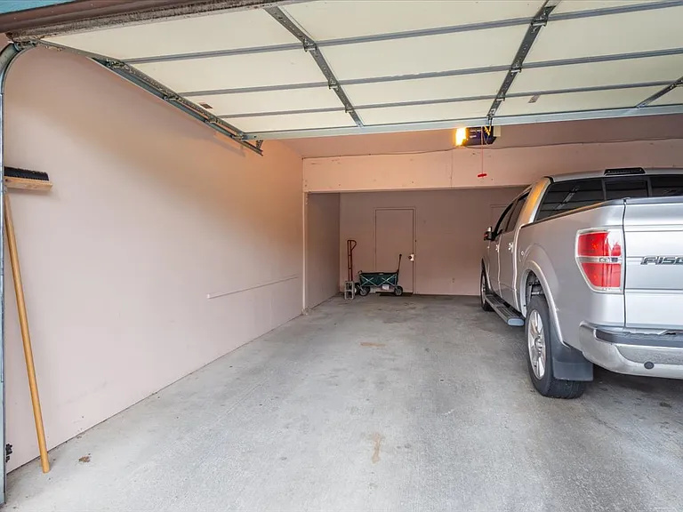 Garage space with huge storage area behind the door at the back.