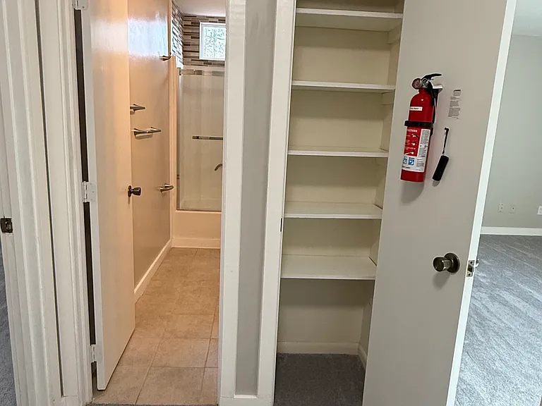 Upstairs hall area to bathroom and storage attic (smoke and CO2 detectors with fire extinguisher)