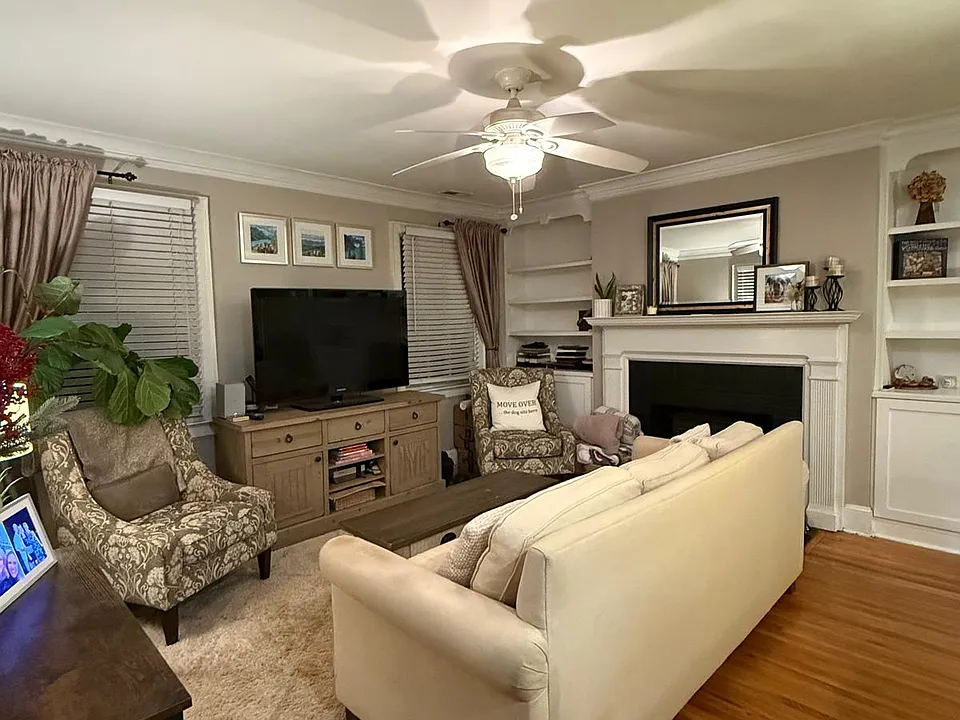 Living Room with Built-in Bookshelves and Ample Storage. Fireplace (not in operation)