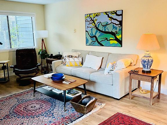 The living room is spacious enough for a full sized sofa.