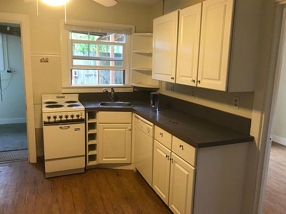 Well lit, open kitchen. To the left is the laundry room.