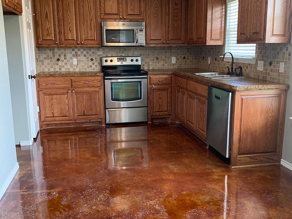 Kitchen features custom wood cabinets, stainless appliances, & more