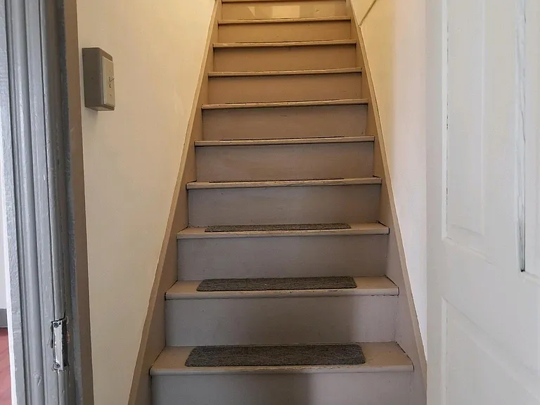 Steps to upstairs bedroom and storage