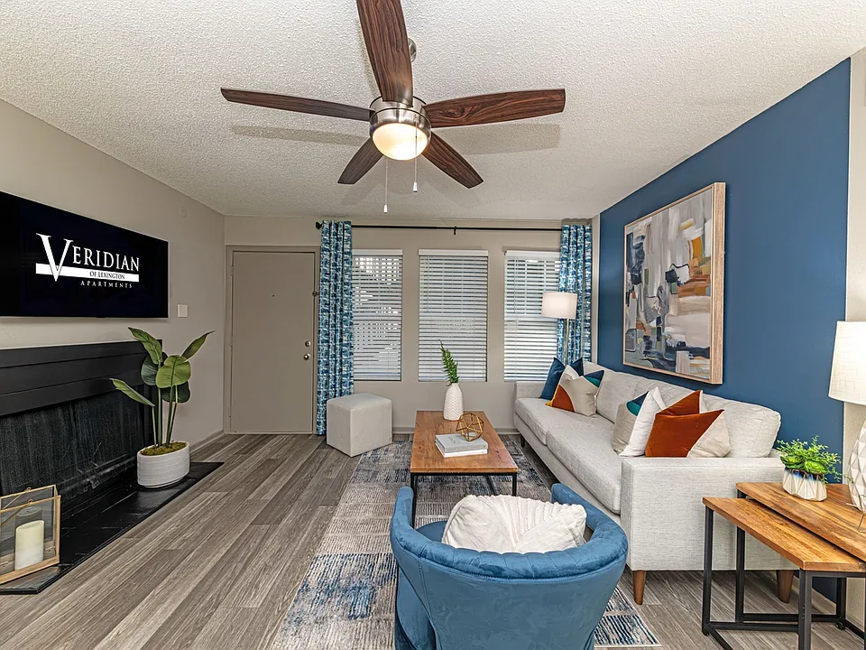 Spacious living room with hardwood-style flooring and overhead lighting