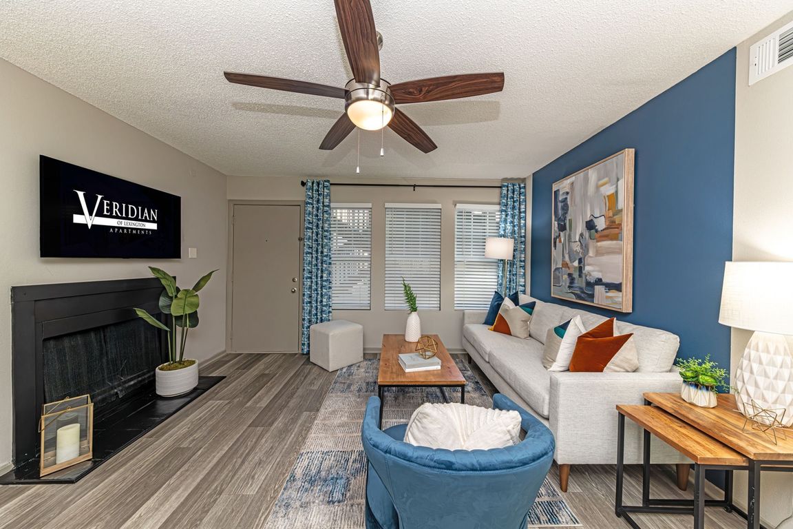 Spacious living room with hardwood-style flooring and overhead lighting