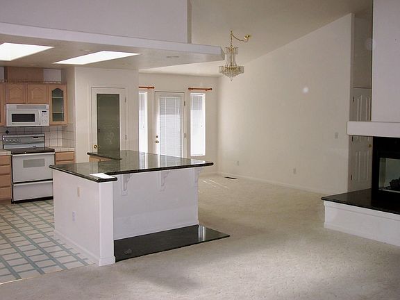 Great view of the kitchen and dining room showing the see-through fireplace.
