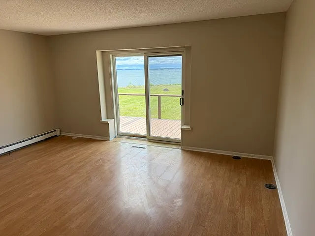 Primary bedroom with sliding door to large, outdoor deck
