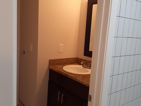 Smaller vanity in bath area.