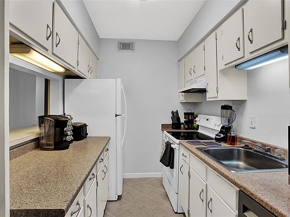 Lots of counter space and cabinets with a pantry.
