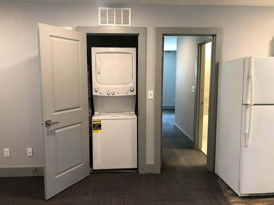 in-unit washer and dryer (through the door you can see the entry to one bedroom and bathroom)