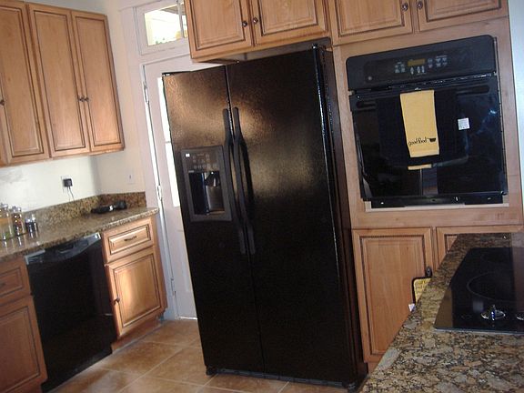 kitchen with travertine tile, granite countertop 