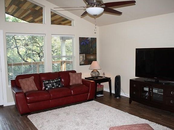 Open living area with vaulted ceilings and large windows for wonderful natural light-large deck off living area, nestled in the trees