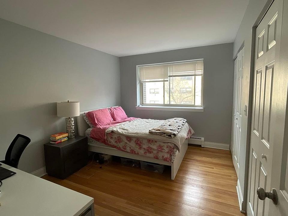 Bedroom with two full closets and space for king sized bed and desk.