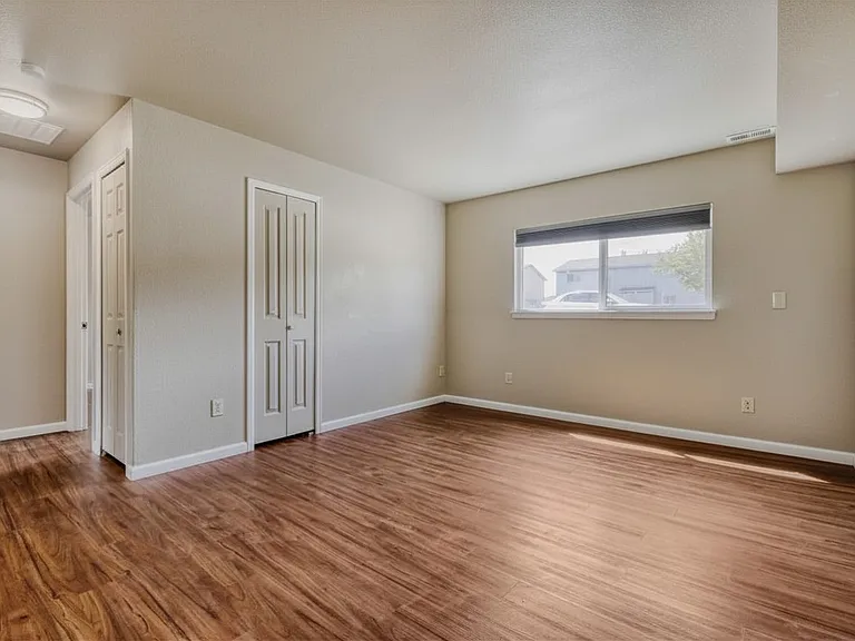 Bright dining area featuring warm natural light, updated flooring, and neutral walls.