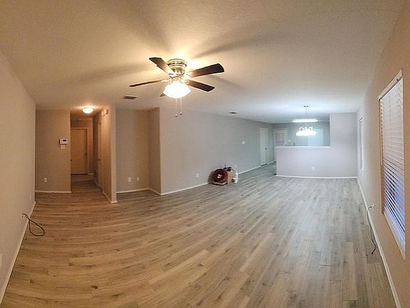 View from Front Entry looking at Living room, Dining room, & Kitchen further back.