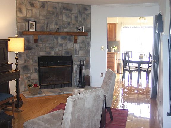SPACIOUS LIVING ROOM WITH BAMBOO FLOOR & STONE FIREPLACE!