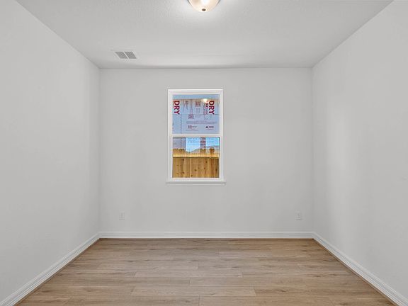 Private study with French doors, beautiful flooring, and large windows-perfect for work, creativity,