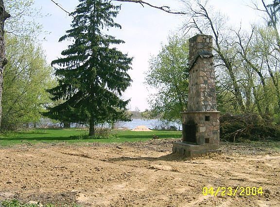 view of where the cabin was, field stone fireplace exists