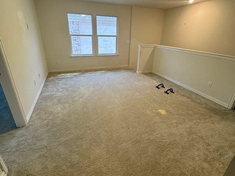 Spacious den/living roomarea at top of stairs.