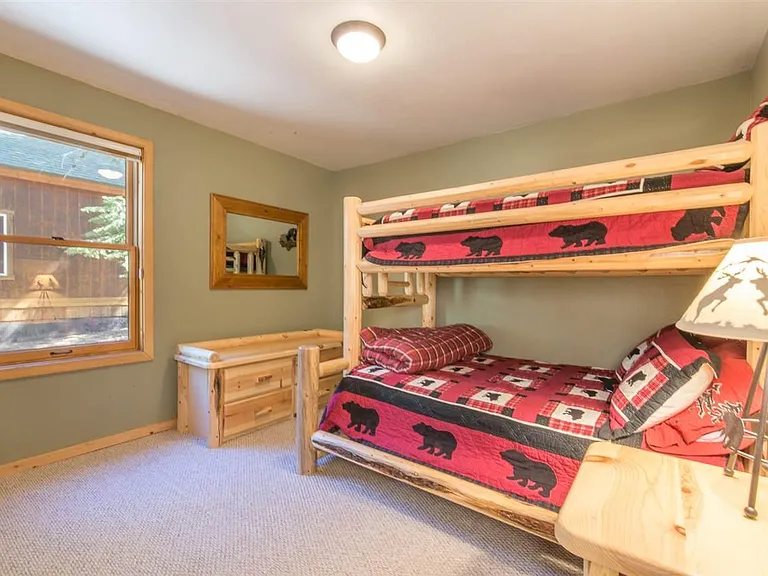 Bedroom 2 with a full bed and single bed bunk.