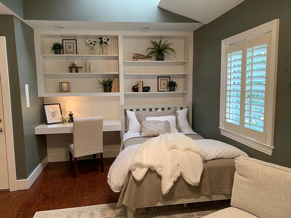 Queen Bed, Built-in Bookcase and Desk with Skylight above for natural lighting.
