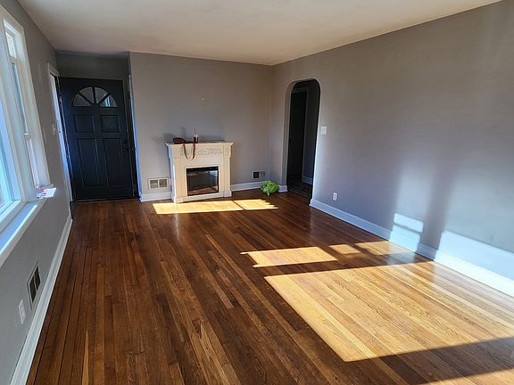 Newly Painted Living Room w/ Sherwin Williams Light Gary! Beautiful Hardwood Floors.