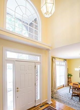 Bright 2 Story Foyer with Palladium window, mahogany wood inlay and columns.