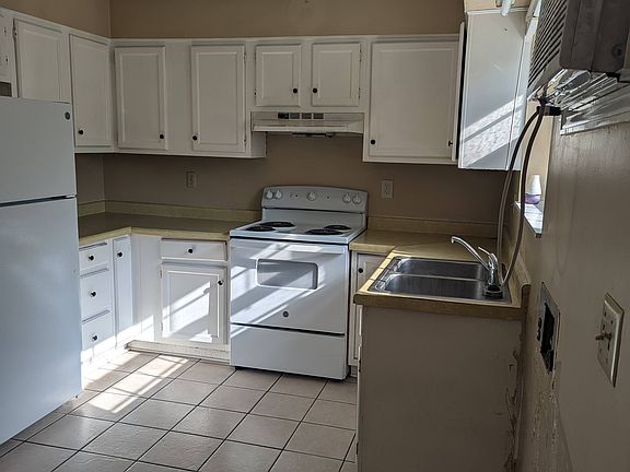 Kitchen with washer and dryer hook ups.