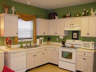 Spacious kitchen with new smooth-top stove and tile floor.