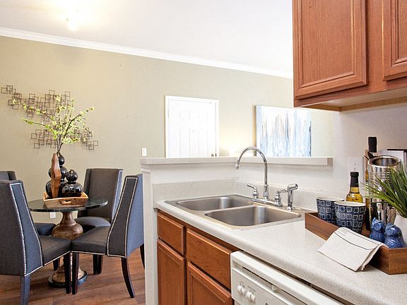 Kitchen with light brown cabinets and white appliances