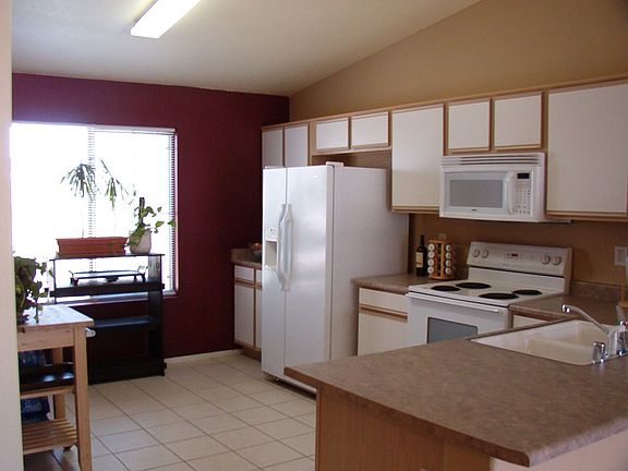 Bright, open kitchen.  Refrigerator stays with the house.