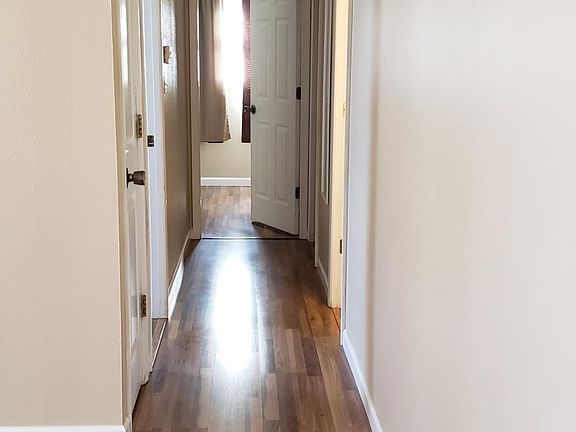 The hallway leading to bathroom and bedrooms