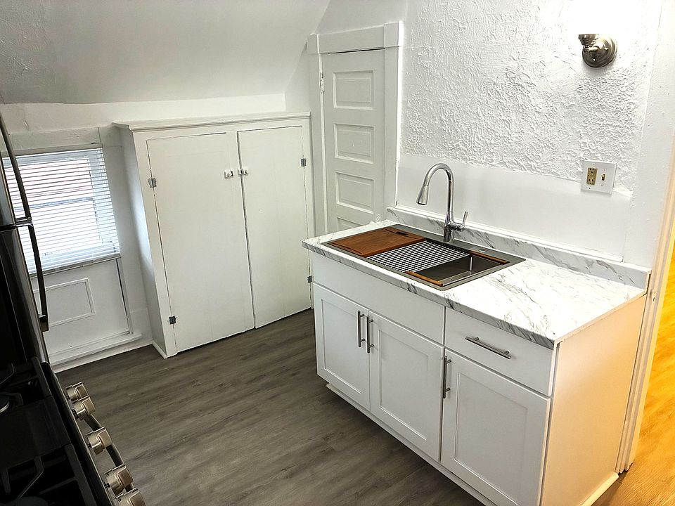 New wood base kitchen cabinet, stainless steel sink. Built-in pantry, and additional storage pantry.