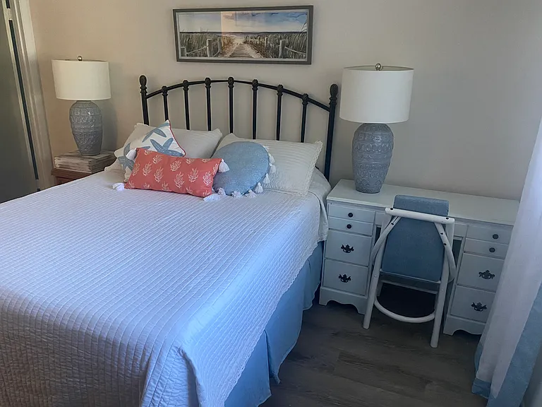 Master Bedroom has a bed, desk and a full dresser with mirror.