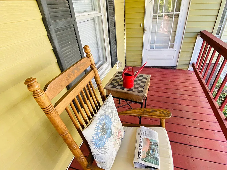 The front side covered porch door enters the First bedroom and conveniently offers a second entrance