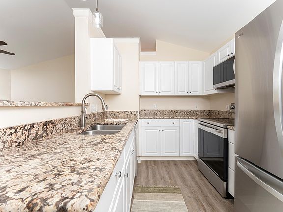 Kitchen with granite counter tops, new stainless appliances and pantry