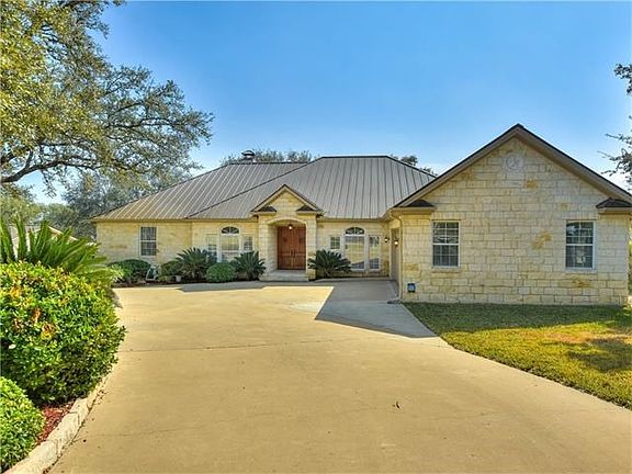 The quality of construction is evident in this custom Texas Stone home with standing seam metal roof.  Elegant, drought resistant landscaping and full sprinkler system.