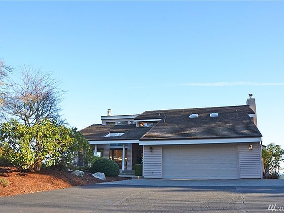 Wide parking area with 2 car garage.