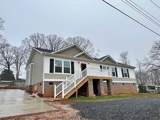 Circle drive way in front and long large concrete drive way on the right side