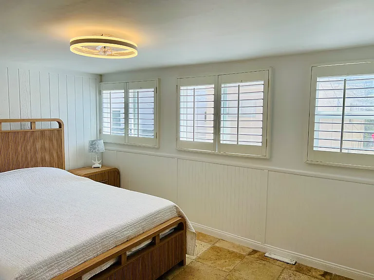 This is the guest queen-sized bedroom with lots of windows