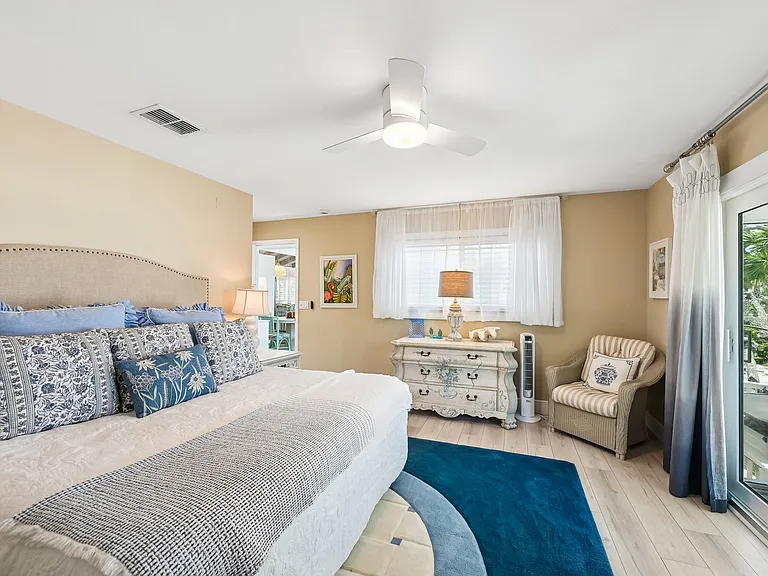 Primary bedroom with a balcony and view