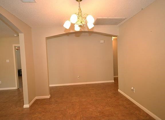 As you enter, you will find the dining room to your left with arched doorways from the foyer and family room.